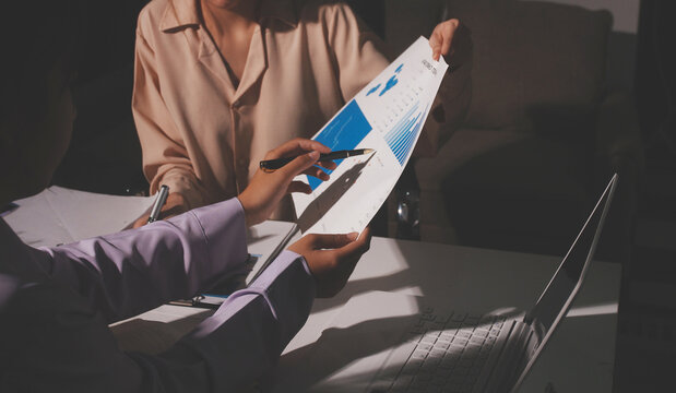Above table with finance papers, graphs and big data during teamwork meeting with accounting or marketing team discussing budget, strategy or growth development. Closeup of SEO team doing research - Powered by Adobe