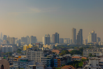 Fototapeta premium Cityscape with height buildings and construction works, Smog or dust PM 2.5 (Particulate matter with diameter of less than 2.5 micron) Bad weather and dangerous air pollution in Bangkok, Thailand.