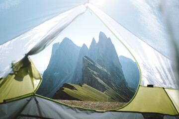 Tent view of rugged mountain peaks in the Italian Dolomites during sunrise, Seceda, South Tyrol, Italy