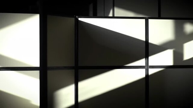 Sunlight creating shadows on office cubicles, creating a business backdrop, office space background with graphic shapes of light.