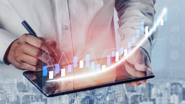 A businessman uses a digital tablet to analyze market trends in a modern office, showcasing the importance of technology in financial growth and strategic planning. Copula - Powered by Adobe