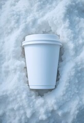 A blank white paper cup mockup is lying on winter snow