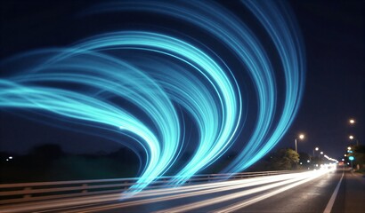 Night highway glowing blue light trails swirl above cars driving under dark sky.
