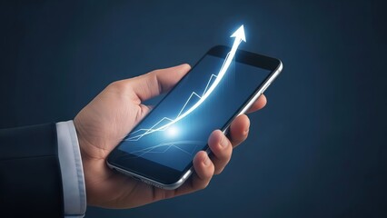 A hand holding a smartphone with a rising graph on the screen