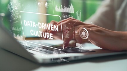 Hands Typing on Laptop with Overlay of Digital Graphics Showing Concepts of Data-Driven Culture and Analytics. Asymptotic smart data analytic.