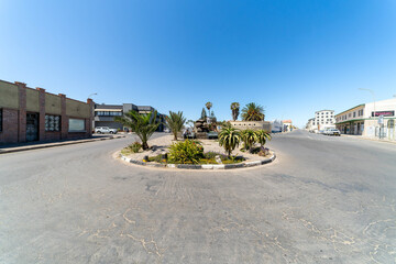 Colorful colonial buildings in Lüderitz, a small coastal town in Namibia, facing the Atlantic Ocean. Historic German architecture contrasts with desert landscapes, harbor views. © coffeinlix 