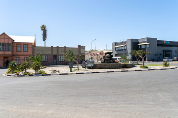 Colorful colonial buildings in Lüderitz, a small coastal town in Namibia, facing the Atlantic Ocean. Historic German architecture contrasts with desert landscapes, harbor views. © coffeinlix 