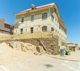 Colorful colonial buildings in Lüderitz, a small coastal town in Namibia, facing the Atlantic Ocean. Historic German architecture contrasts with desert landscapes, harbor views. © coffeinlix 