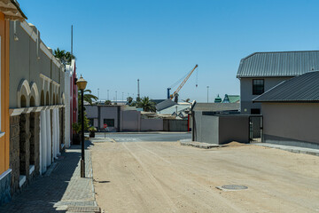Colorful colonial buildings in Lüderitz, a small coastal town in Namibia, facing the Atlantic Ocean. Historic German architecture contrasts with desert landscapes, harbor views. © coffeinlix 