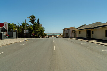 Colorful colonial buildings in Lüderitz, a small coastal town in Namibia, facing the Atlantic Ocean. Historic German architecture contrasts with desert landscapes, harbor views. © coffeinlix 