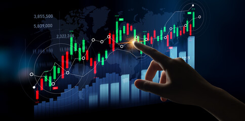 A hand interacts with a digital display of stock market data visualization, showcasing financial trends through colorful graphs and indicators on a dark background. Scalp