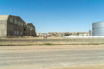 Colorful colonial buildings in Lüderitz, a small coastal town in Namibia, facing the Atlantic Ocean. Historic German architecture contrasts with desert landscapes, harbor views. © coffeinlix 