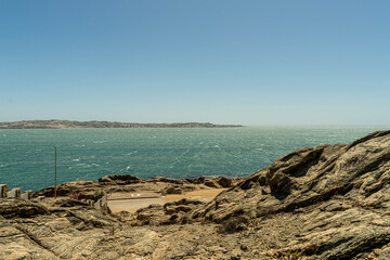 Colorful colonial buildings in Lüderitz, a small coastal town in Namibia, facing the Atlantic Ocean. Historic German architecture contrasts with desert landscapes, harbor views. © coffeinlix 