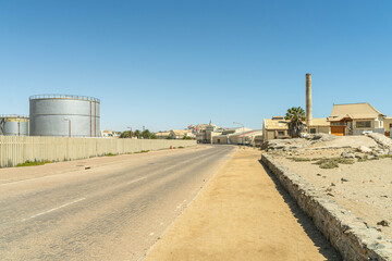 Colorful colonial buildings in Lüderitz, a small coastal town in Namibia, facing the Atlantic Ocean. Historic German architecture contrasts with desert landscapes, harbor views. © coffeinlix 