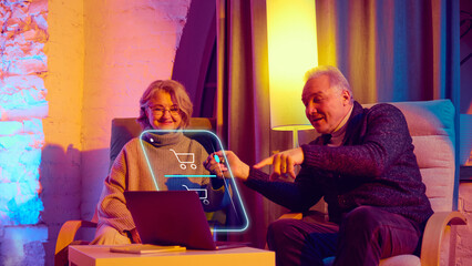 Elderly couple using digital assistant for online shopping at home. Concept of senior ecommerce promotion, online shopping and delivery services, retail platforms, banking apps.