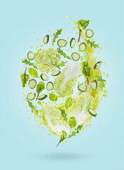 Fresh green vegetable smoothie fly with ingredients - greens, cucumber in splashing of explosion green juice on blue background. Perfect for organic food advertising, detox menu, fitness, juice label.