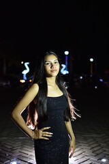 Fototapeta premium A pretty and serious young teenager dressed in a black dress