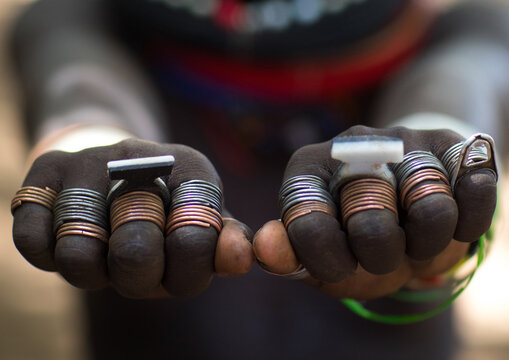 Sudanese Toposa tribe girl refugee showing her hand rings, Omo Valley, Kangate, Ethiopia