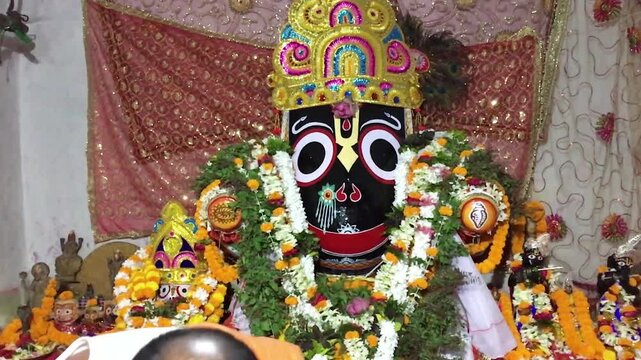 Lord Jagannath Idol with Ornate Crown and Floral Garlands, Decorated Hindu Deity in Odisha Tradition, Devotional Temple Worship, Spiritual and Cultural Heritage