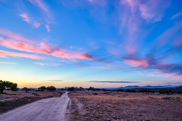 Scenic pathway in Extremadura at sunset with vibrant clouds and vast landscapes for stock photography