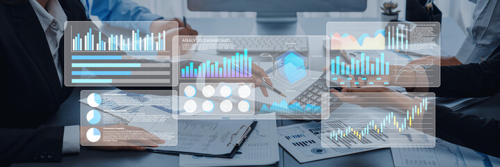 A business team collaborates on data analysis, surrounded by charts and reports. They utilize digital tools to facilitate a productive meeting in a modern office environment. Gantry
