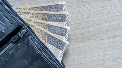 Polish 200 Zloty Banknotes Protruding from Black Leather Wallet