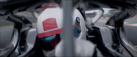 Fototapeta premium A close-up of a race car driver in motion, captured while speeding on a track