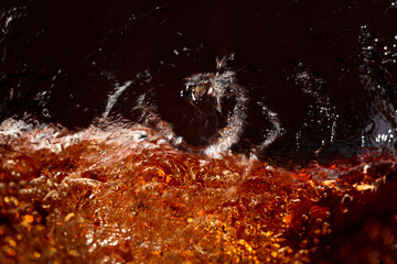  Macro shot of cooling drink with bubbles in motion.
