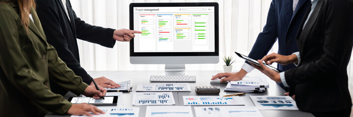 Panorama shot analyst team utilizing BI Fintech to analyze financial report with laptop....