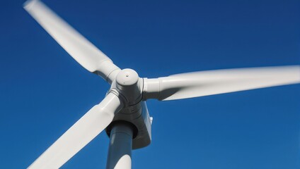 Wind turbine blades spinning in motion against a clear blue sky for renewable energy generation.