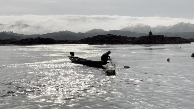Silhouette of  sunrise , Thai fishermen are catching fish in the Mekong River, Nong Khai, Thailand.