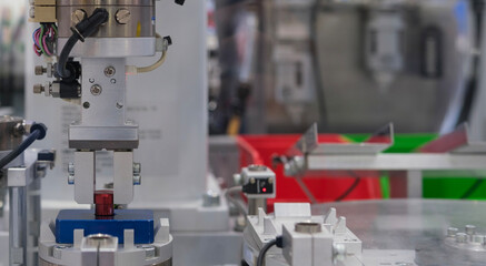 Close up industrial automation robotic working with red metalwork on smart manufacturing and right copy space, industry 4.0 and modern technology