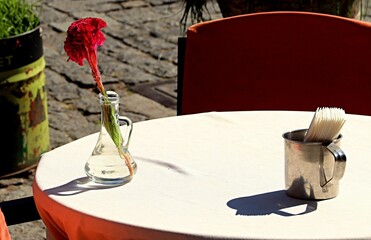 Outdoor restaurant tables on a city street, restaurant interior