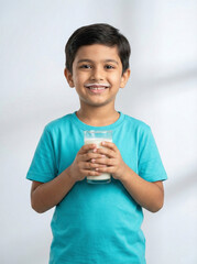 happy young indian boy with milk mustache holding glass of milk standing front view head to thigh for child nutrition concept