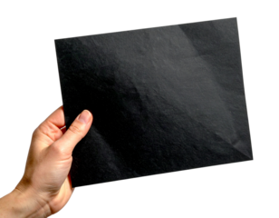 Hand holding blank black sheet of paper isolated on white background