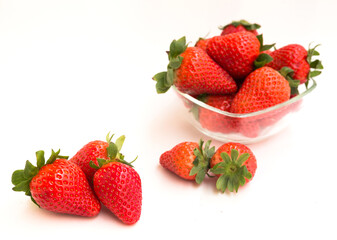 fresh appetizing strawberries in a glass bowl on white background