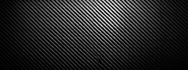 A grayscale image displaying a diagonal textured pattern. The lines appear to have a reflective effect and create depth within the image