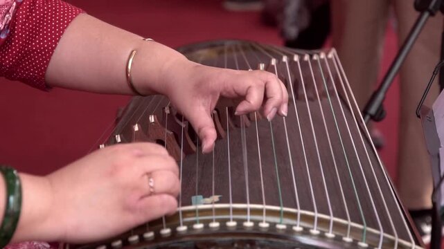 Chinese traditional musician playing Chinese guzheng