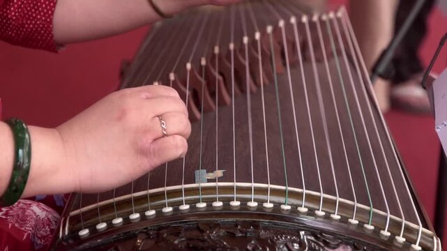 Chinese traditional musician playing Chinese guzheng