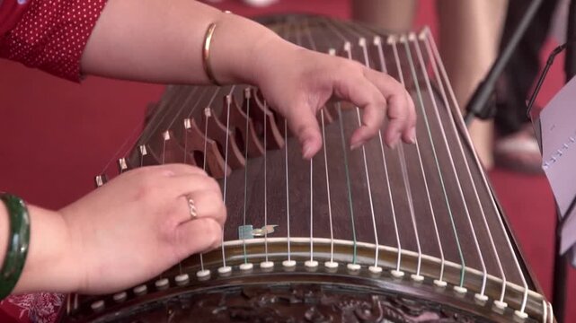 Chinese traditional musician playing Chinese guzheng