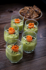 Smoked salmon shot glasses guacamole served with homemade crackers. High quality photo