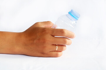 Hand Holding Clear Plastic Bottle with Blue Cap