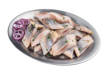 Cured herring slices with skin served with onion and herbs on wooden board. Light iisolated background