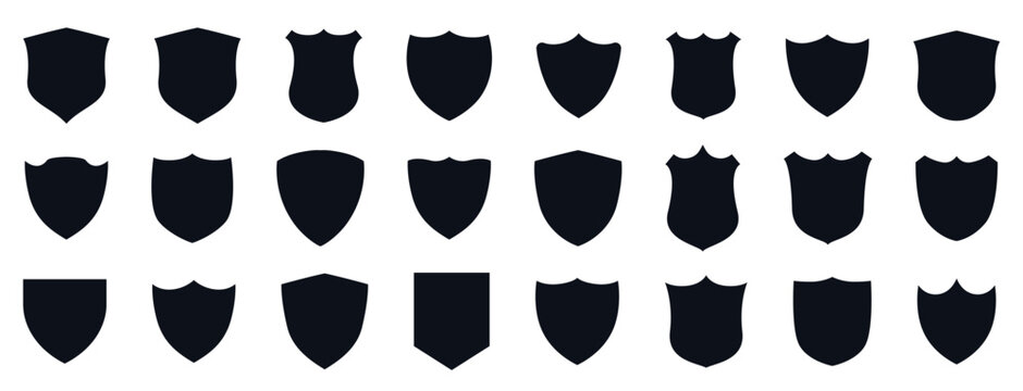 Professional collection of 24 black shield silhouettes in various shapes for logo design, security branding, and heraldic emblems.