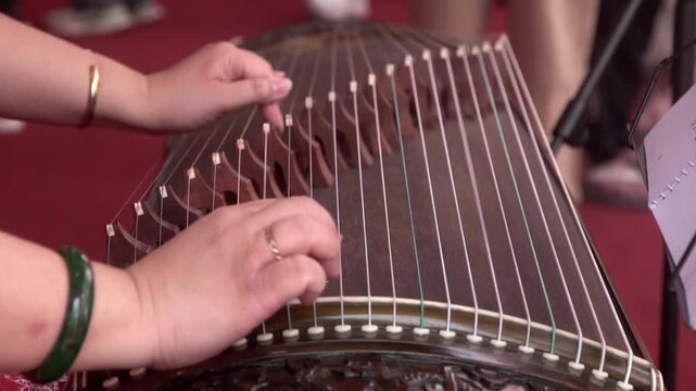 Chinese traditional musician playing Chinese guzheng