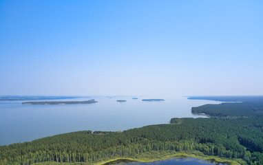 Aerial photo of forest boggy lake in the Karakansky pine forest near the shore of the Ob reservoir.