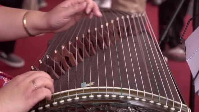 Chinese traditional musician playing Chinese guzheng