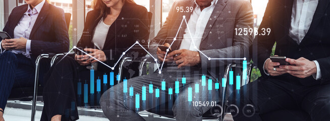 Diverse business professionals engage with mobile devices, analyzing financial data and trends in a modern office. Concept of teamwork and technology in finance. Scalp