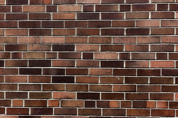 Vintage Brick Wall Texture: Aged Rustic Bricks with Moss in Urban Setting, Staggered Bond, Close-up