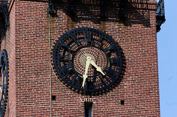 Historic Landmark Clock Tower: Ornate Clock On Red Brick Building With Iron Railings Urban Setting